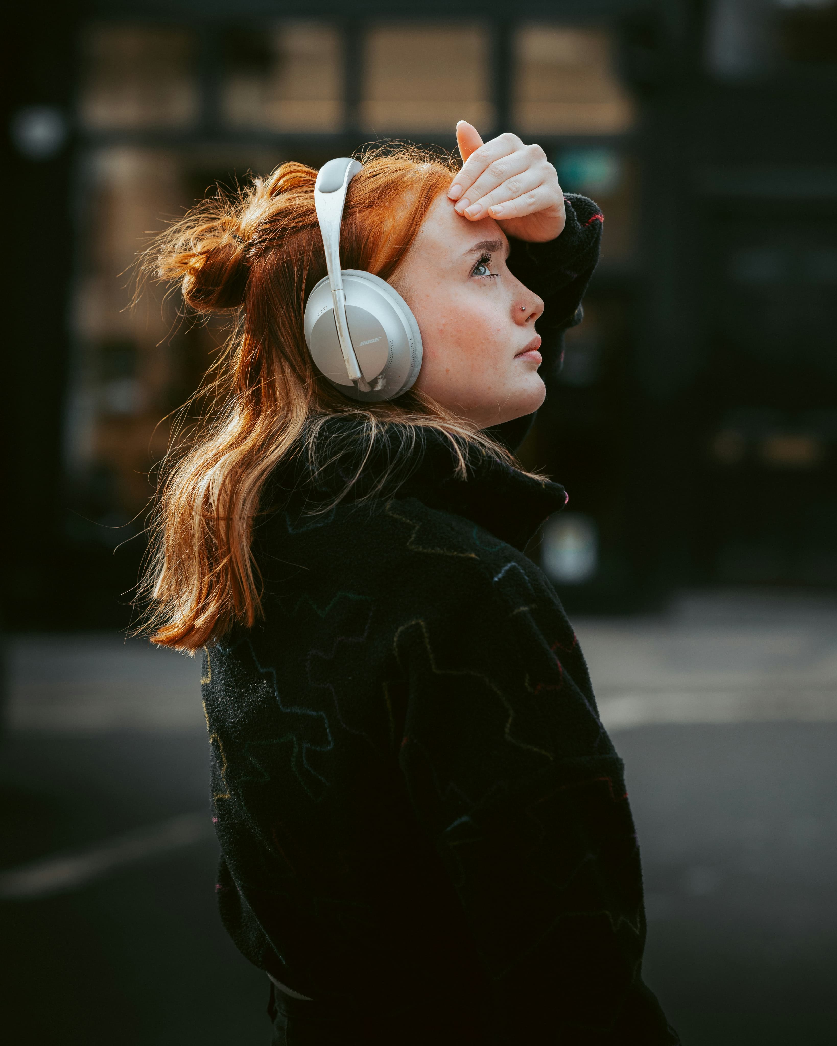 Woman with headphones on looking up
